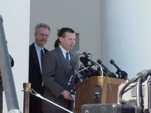 Public Information Officer Craig Waters at the podium addressing the media with Clerk of Court Tom Hall. December 5, 2000.