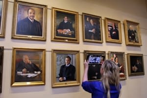 The Florida Supreme Court has been closed to visitors since March 2020, but school groups, civic organizations, and leadership groups have been able to take virtual tours of the building.  In addition to learning about Florida&rsquo;s judicial branch, the different levels of courts in Florida, and how the supreme court operates, viewers are introduced to the public areas of the building.  Here, Ms Emilie Rietow, the supreme court&rsquo;s education and information administrator, shows visitors the portrait gallery.