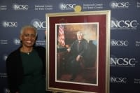 Justice Quince with a limited-edition print of the final portrait of the late Chief Justice Warren E. Burger who founded the NCSC in 1971.