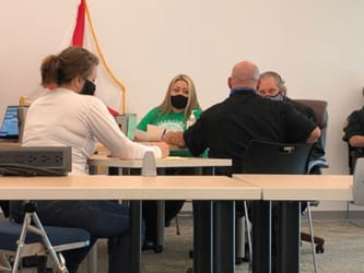 Circuit Judge Lon Arend (pictured far right) conducts a hearing during Amnesty Court at the Veterans Stand Down event.